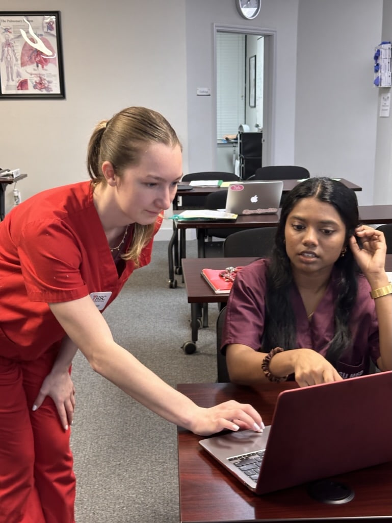 HSC coach providing one-on-one support to a pre-health student during a coaching session